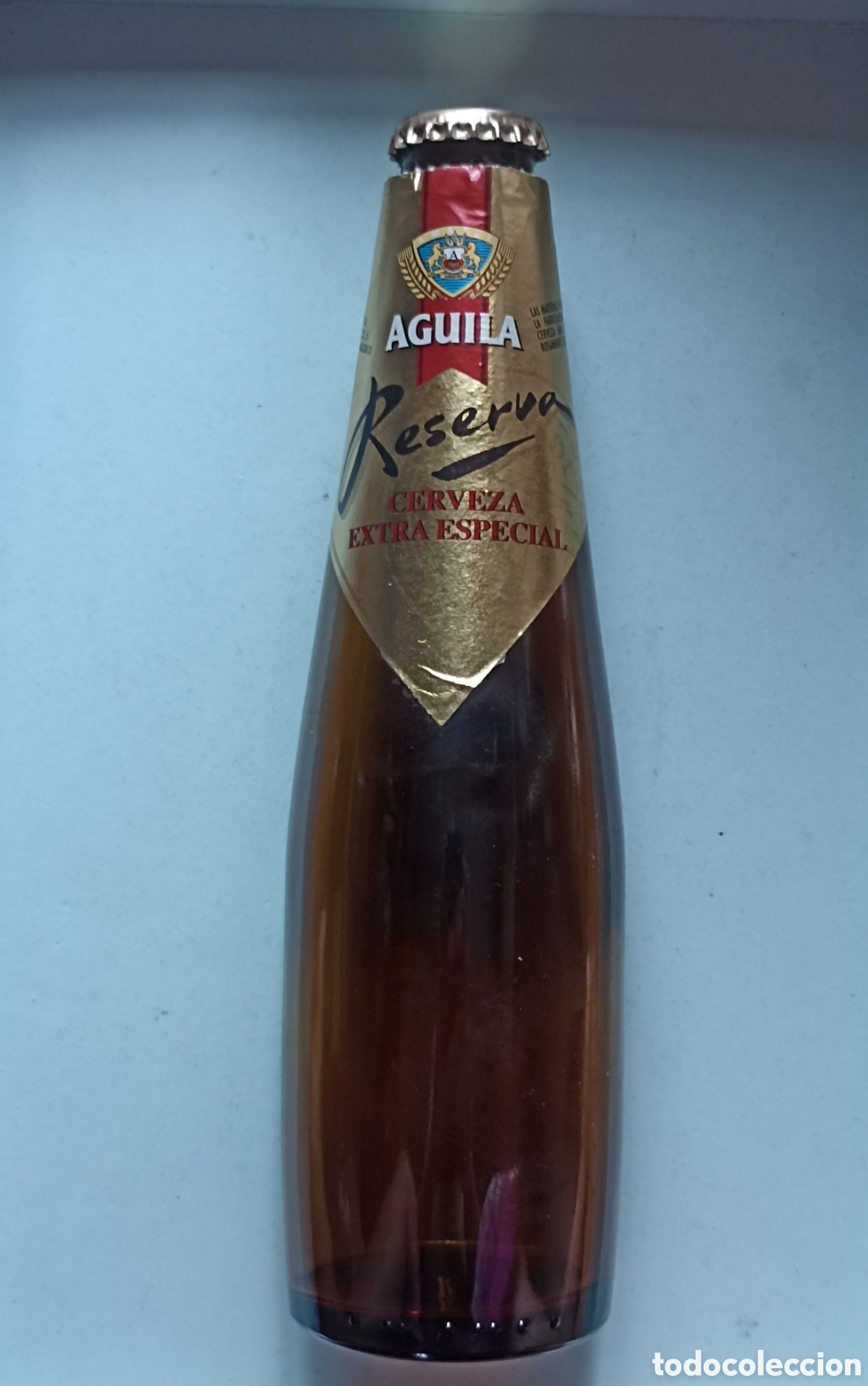 Coleccionismo de cervezas: Botella cerveza &Aacute;guila reserva extra especial vac&iacute;a con chapa 330 ml
