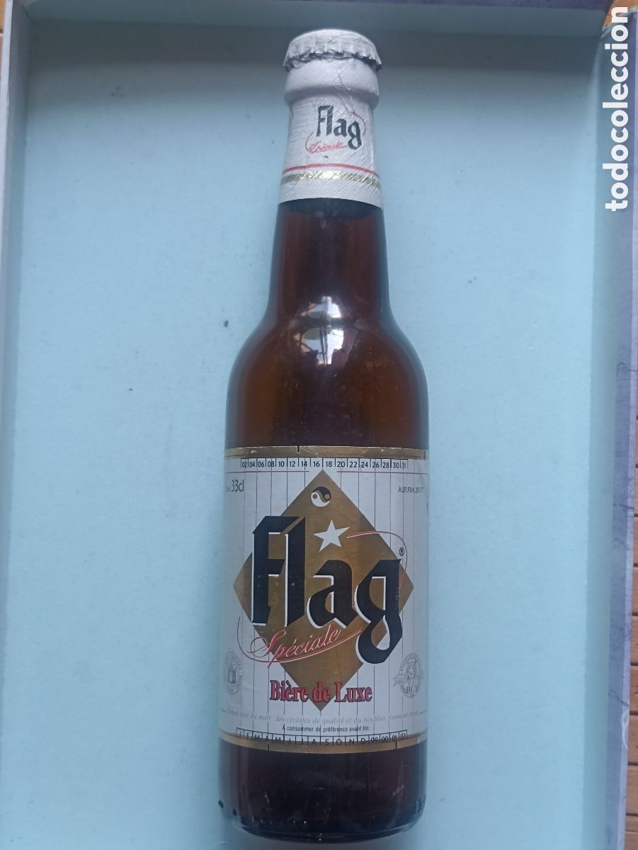 Coleccionismo de cervezas: Botella cerveza Flag Senegal vac&iacute;a con chapa 330 ml
