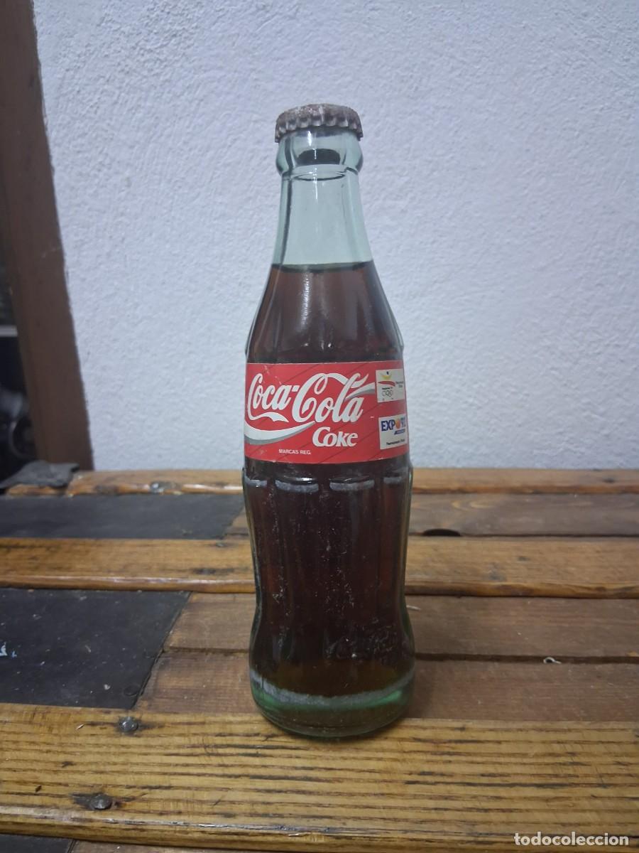 Coleccionismo de Coca-Cola y Pepsi: Botella con chapa llena refresco Coca cola edici&oacute;n Juegos ol&iacute;mpicos Barcelona 1992 y Expo 92 Sevilla