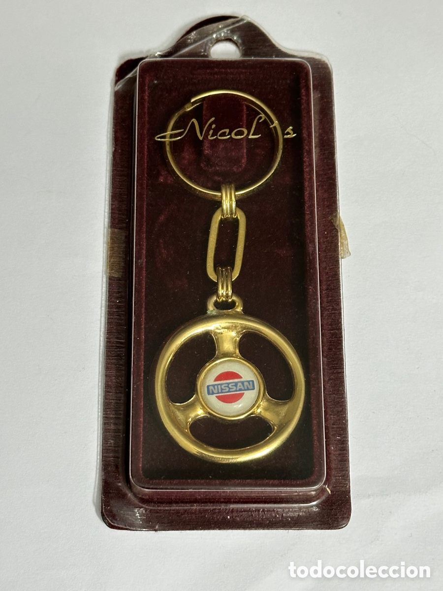 Coleccionismo de llaveros: LLAVERO VOLANTE NISSAN DORADO NUEVO EN SU CAJA