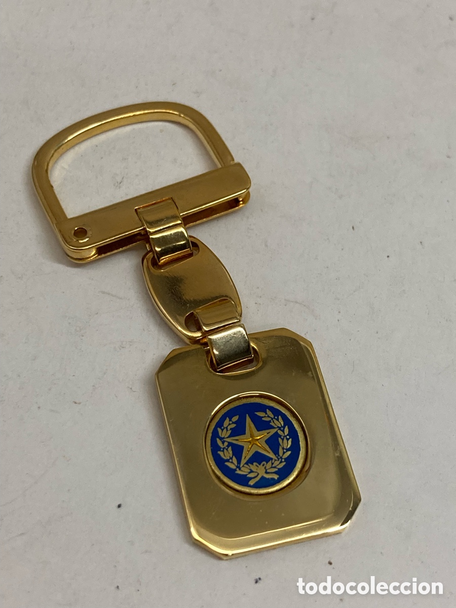 Coleccionismo de llaveros: llavero met&aacute;lico dorado con una placa azul y dorada