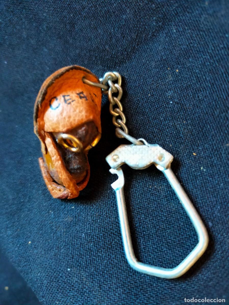 Collection of Keychains: FIGURA FOLCL&Oacute;RICA DE LLAVERO. VINTAGE BRASIL. 70&acute;s. CON CUERO Y SEMILLAS PROTECTORAS OLHO