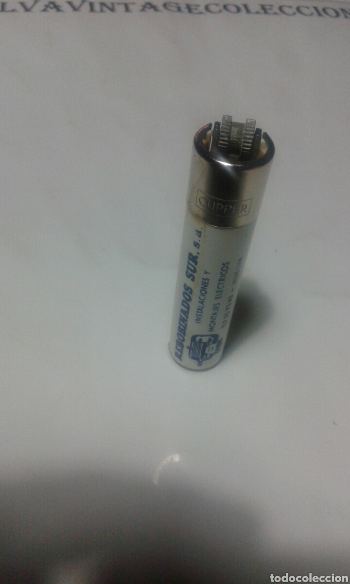 Mecheros: Mechero clipper con rascador redondo y publicidad.