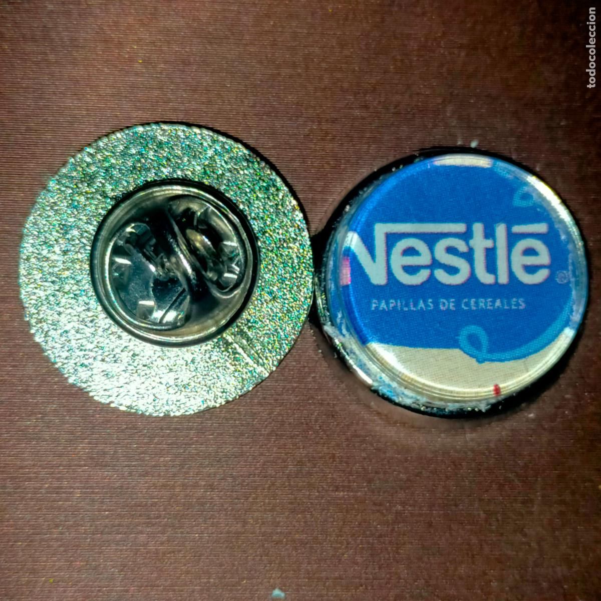 Pin's de collection: PIN REDONDO METAL - publicitario chocolates nestle