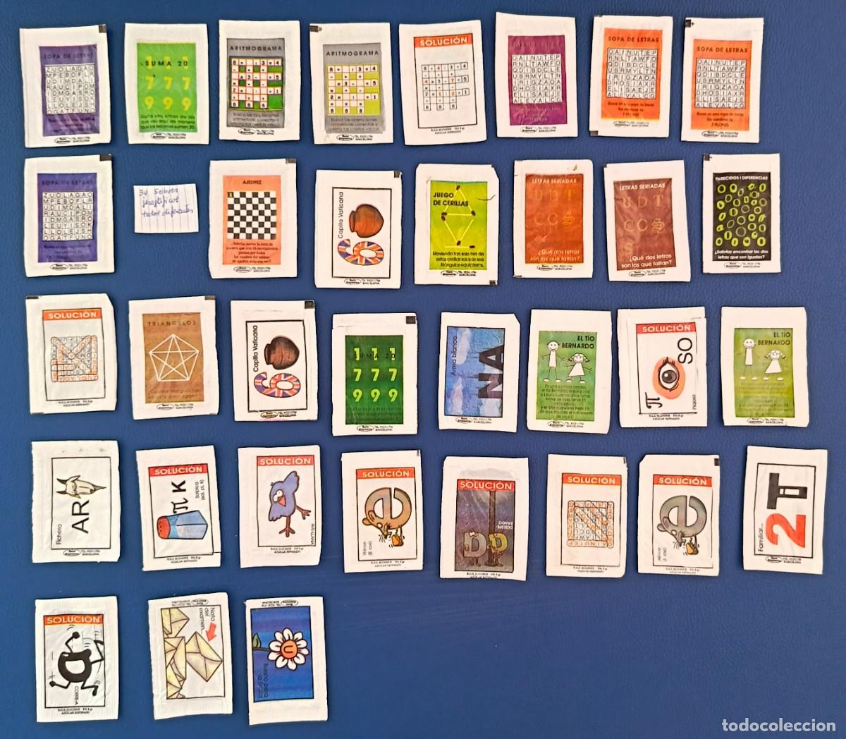 Sobres de az&uacute;car de colecci&oacute;n: 34 Sobres de azucar. Jerogl&iacute;ficos o pasatiempos. Todos diferentes. Cinco abiertos como un libro.