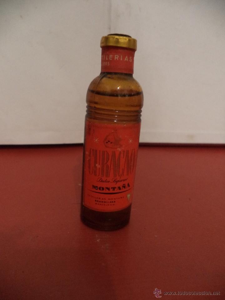 Coleccionismo de vinos y licores: BOTELLIN DE LICOR CURA&Ccedil;AO DULCE SUPERIOR. DESTILER&Iacute;AS MONTA&Ntilde;A. GRANOLLER (BARCELONA).