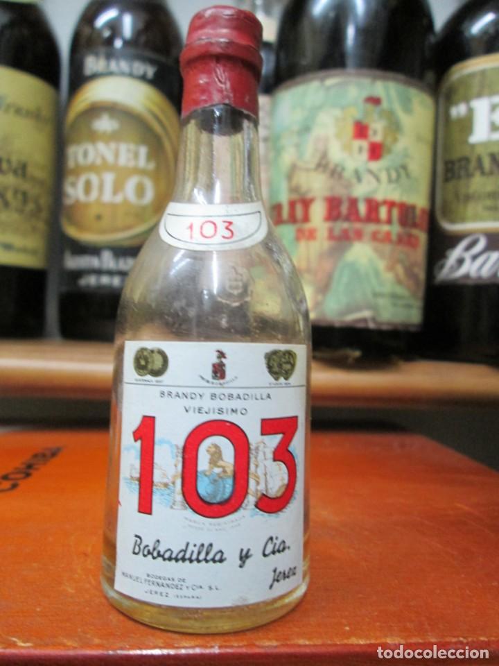 Coleccionismo de vinos y licores: ANTIGUO BOTELLIN BRANDY CO&Ntilde;AC, 103 BOBADILLA Y CIA 11 CM ALTURA