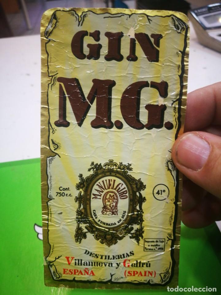 Coleccionismo de vinos y licores: Etiqueta de Ginebra M.G. arrugada
