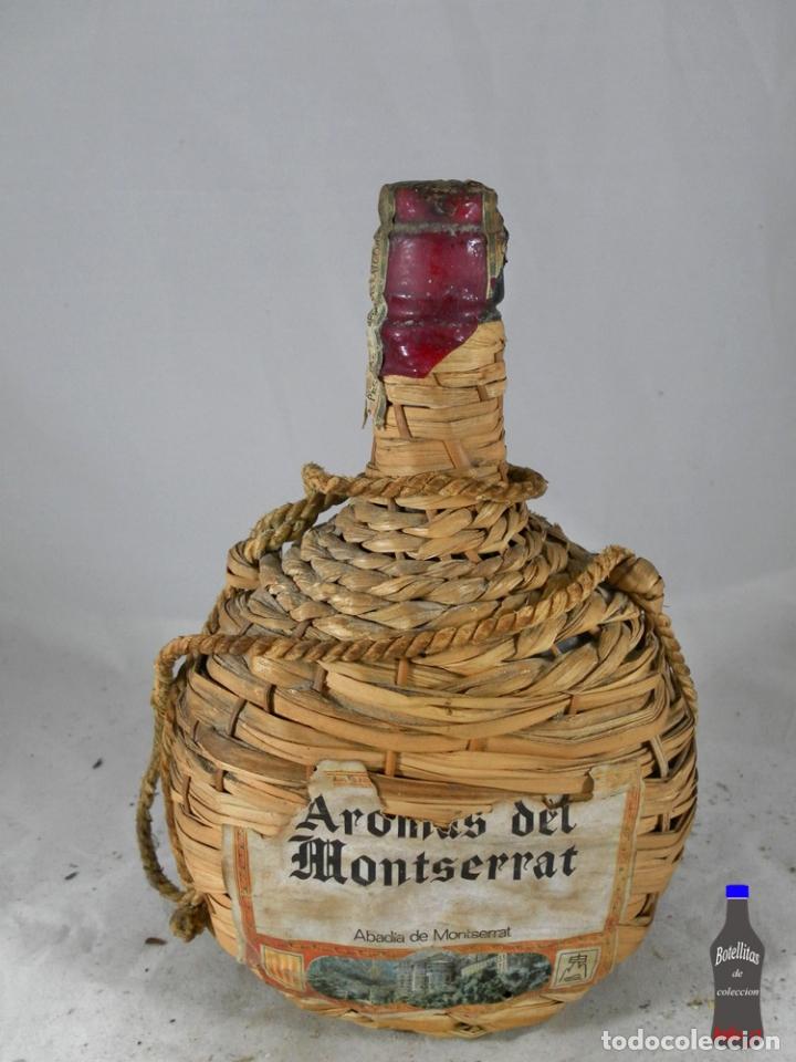 Collection of wines and liquors: BOTELLA GARRAFA MIMBRE AROMAS DEL MONTSERRAT ABADIA DE MONTSERRAT
