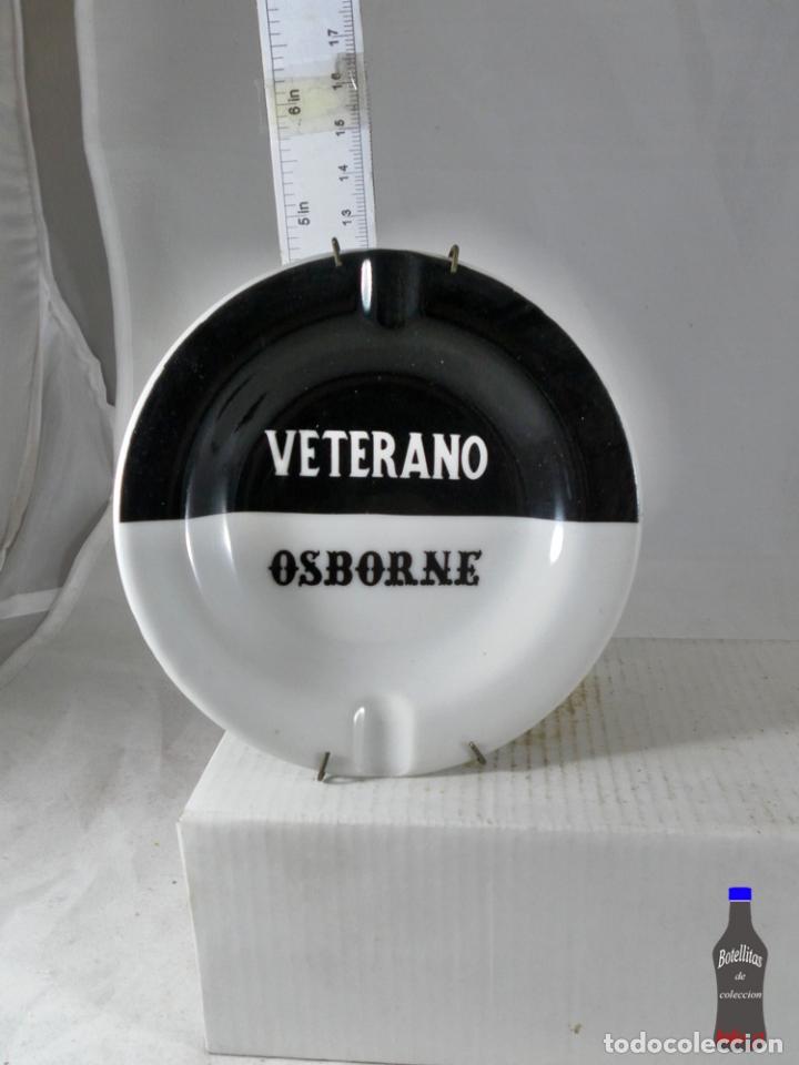 Sammlung von Weinen und Lik&ouml;ren: CENICERO VETERANO OSBORNE NEGRO MAS COLGADOR PARED