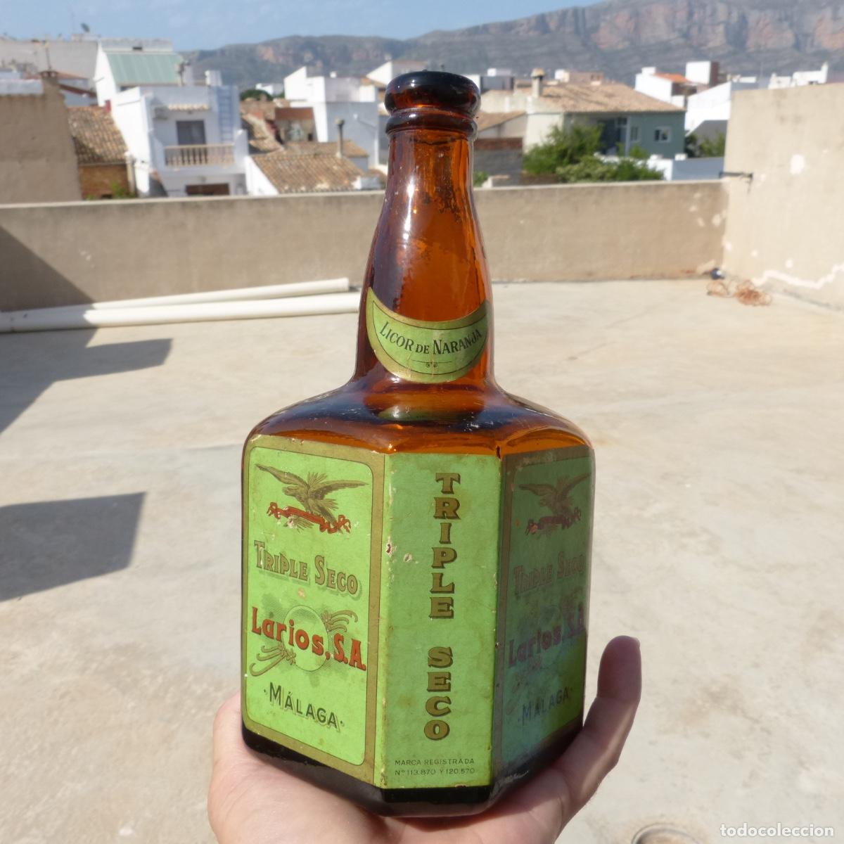 Sammlung von Weinen und Lik&ouml;ren: Antigua botella de Larios triple seco, casi vacia, Malaga, licor de naranja, 23cm, 898gr.