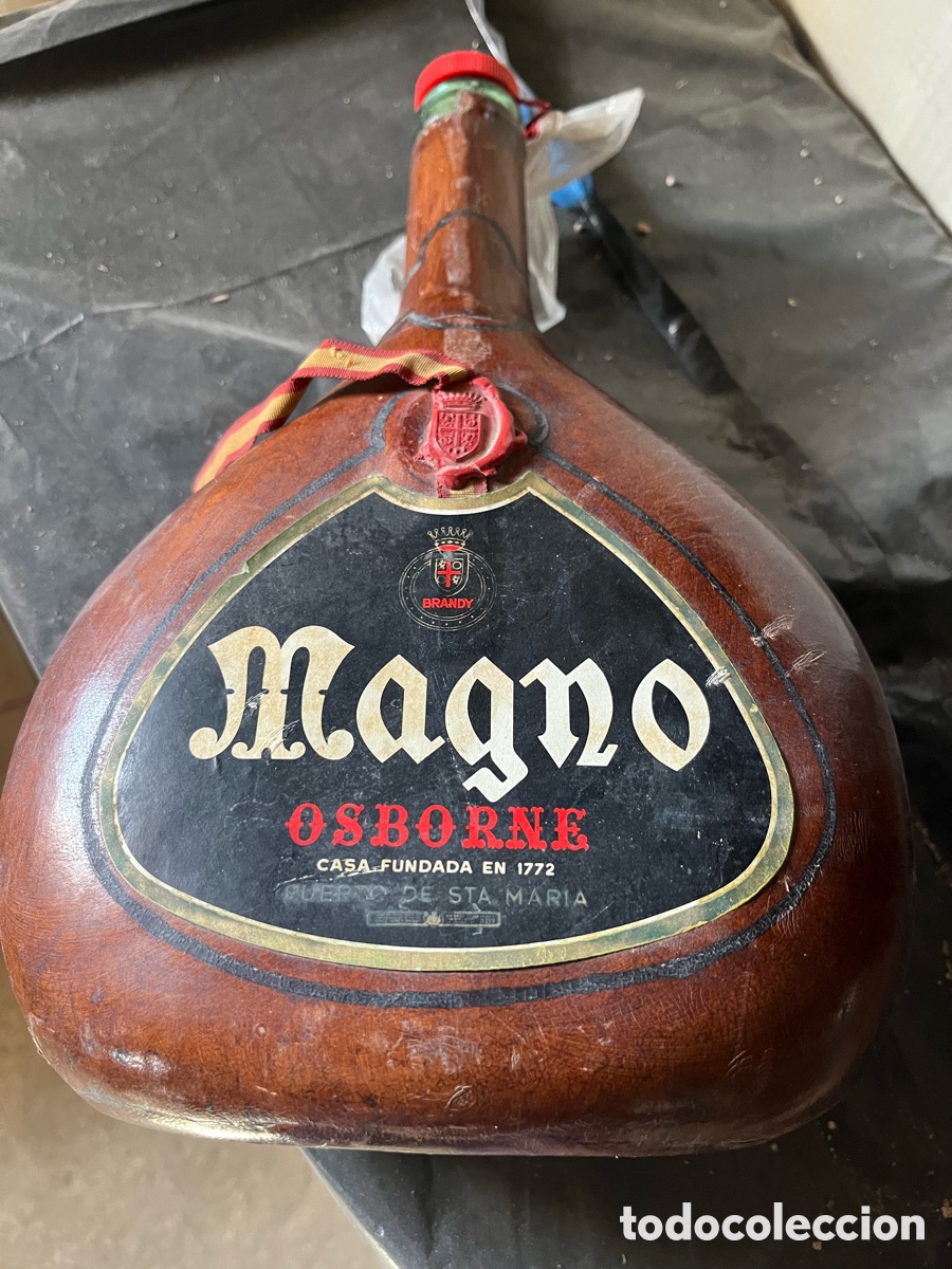 Sammlung von Weinen und Lik&ouml;ren: Antigua botella de BRANDY MAGNO forrada en cuero, vac&iacute;a.