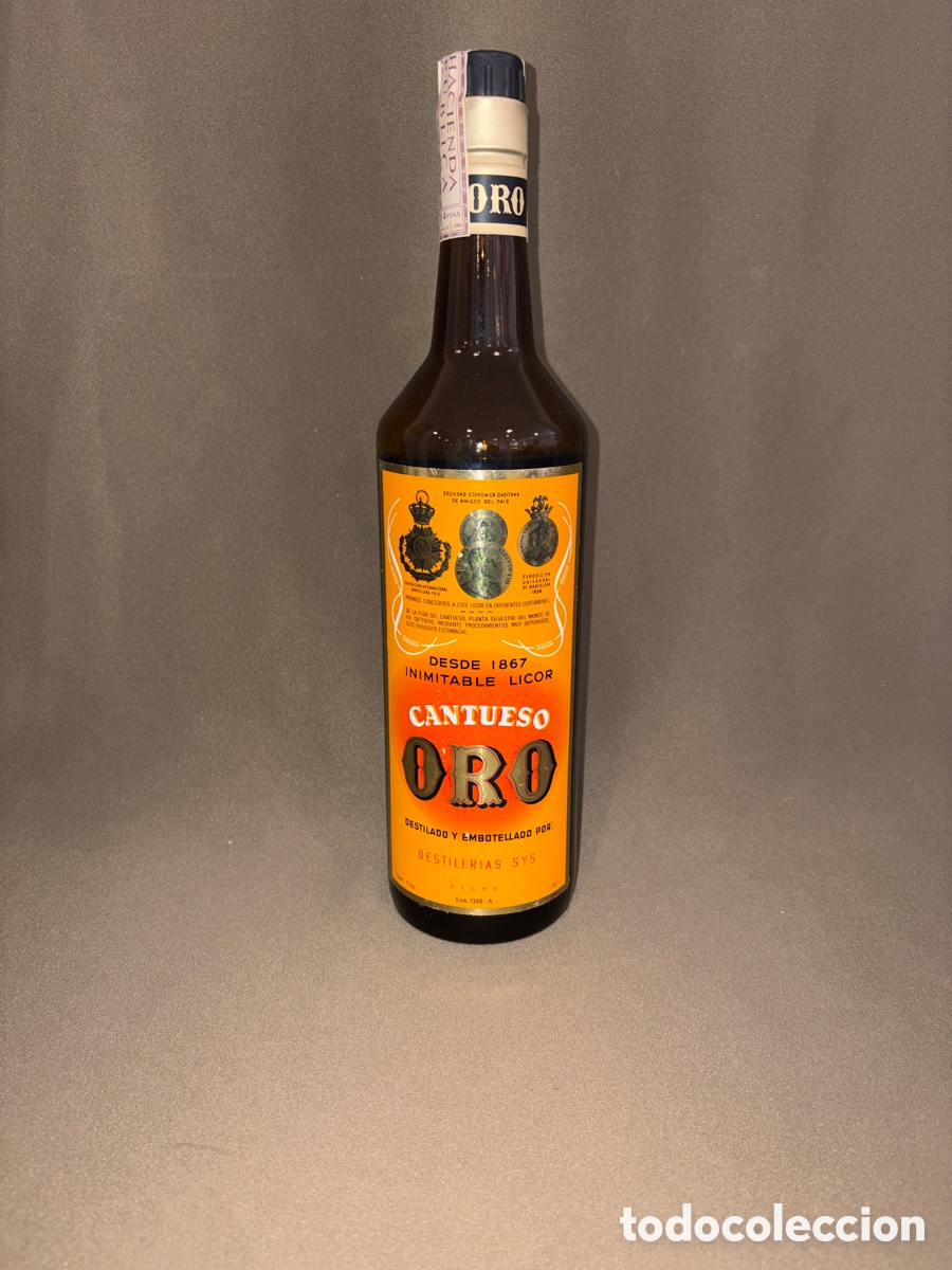 Collectionnisme de vins et liqueurs: Antigua botella CANTUESO ORO,destiler&iacute;as SYS,ELCHE,sello 4 pesetas*LLENA*1 litro