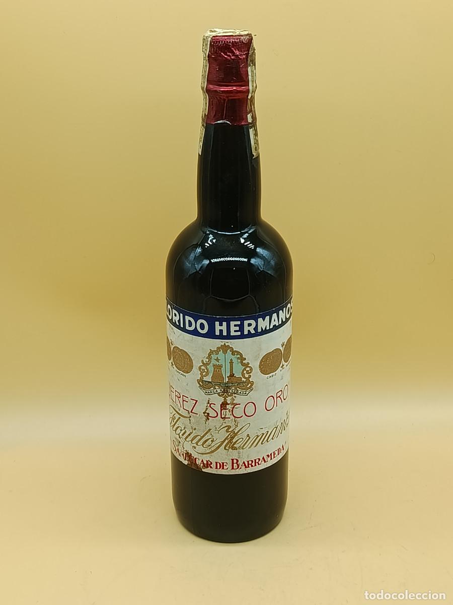 Coleccionismo de vinos y licores: BOTELLA FLORIDO HERMANOS. JEREZ SECO ORO. SAN LUCAR DE BARRAMEDA. 79CL. PRECINTADA.