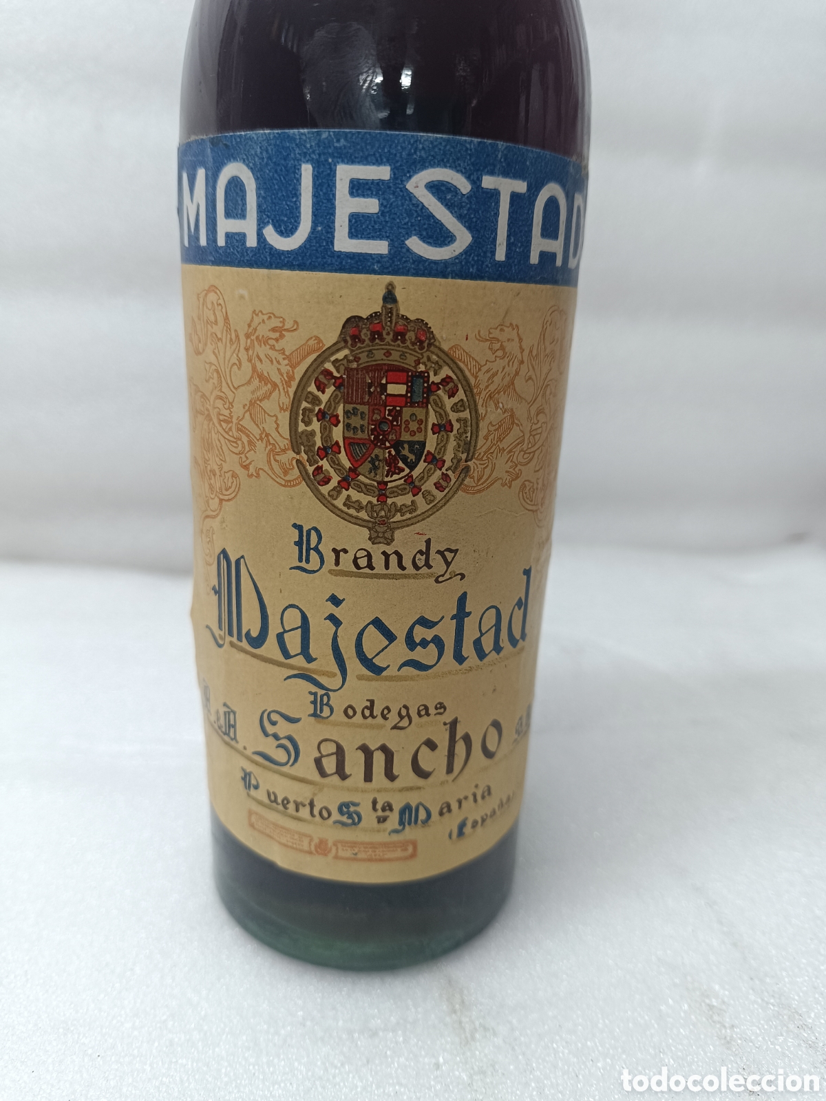 Collection of wines and liquors: ANTIGUA BOTELLA BRANDY CO&Ntilde;AC, MAJESTAD DE BODEGAS SANCHO, IMPUESTO DE 80 CTS