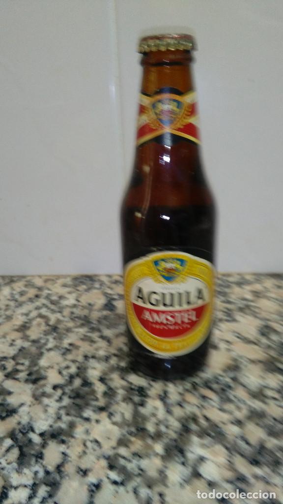 Collectionnisme: BOTELLA CERVEZA AGUILA AMSTELL LIQUIDO ORIGINAL CHAPA CORONA