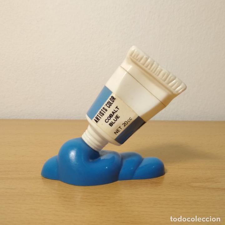 Coleccionismo: Sacapuntas con goma de borrar en forma de tubo de pintura derramada. Color azul. A&ntilde;os 80