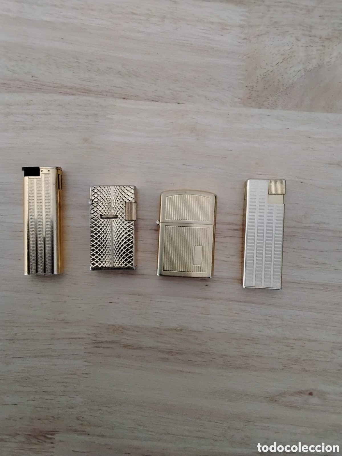 Coleccionismo: CUATRO MECHEROS DORADOS