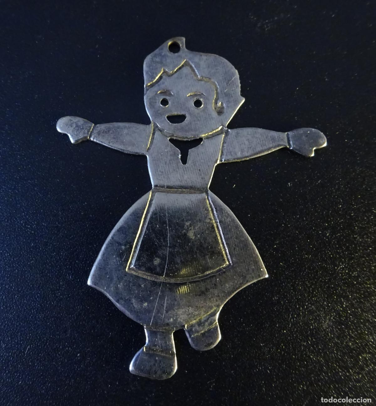 Coleccionismo: COLGANTE TROQUELADO CON FIGURA DE HEIDI. METAL PLATEADO &iquest;PLATA?. 5 X 4 CM