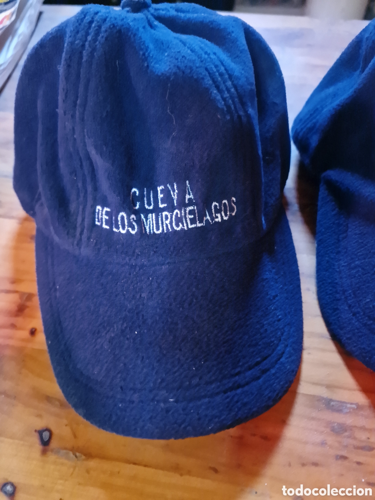 Coleccionismo: Lote 2 gorras azul marino, grabado cueva de los murci&eacute;lagos, con orejeras,ver fotos