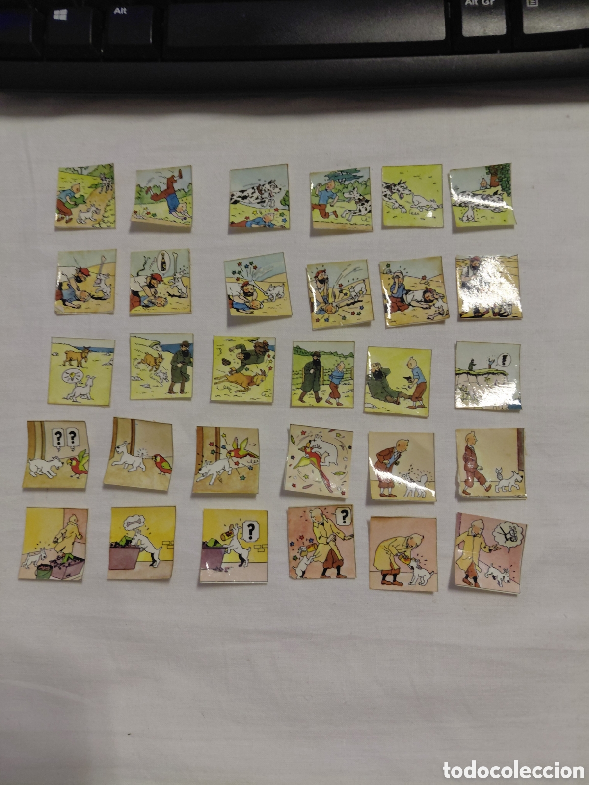 Coleccionismo cromos antiguos: TINTIN TIRAS ADHESIVAS LOTE PANRICO A&Ntilde;OS 80.HAN ESTADO PEGADAS EN LA PORTADA DE UN LIBRO