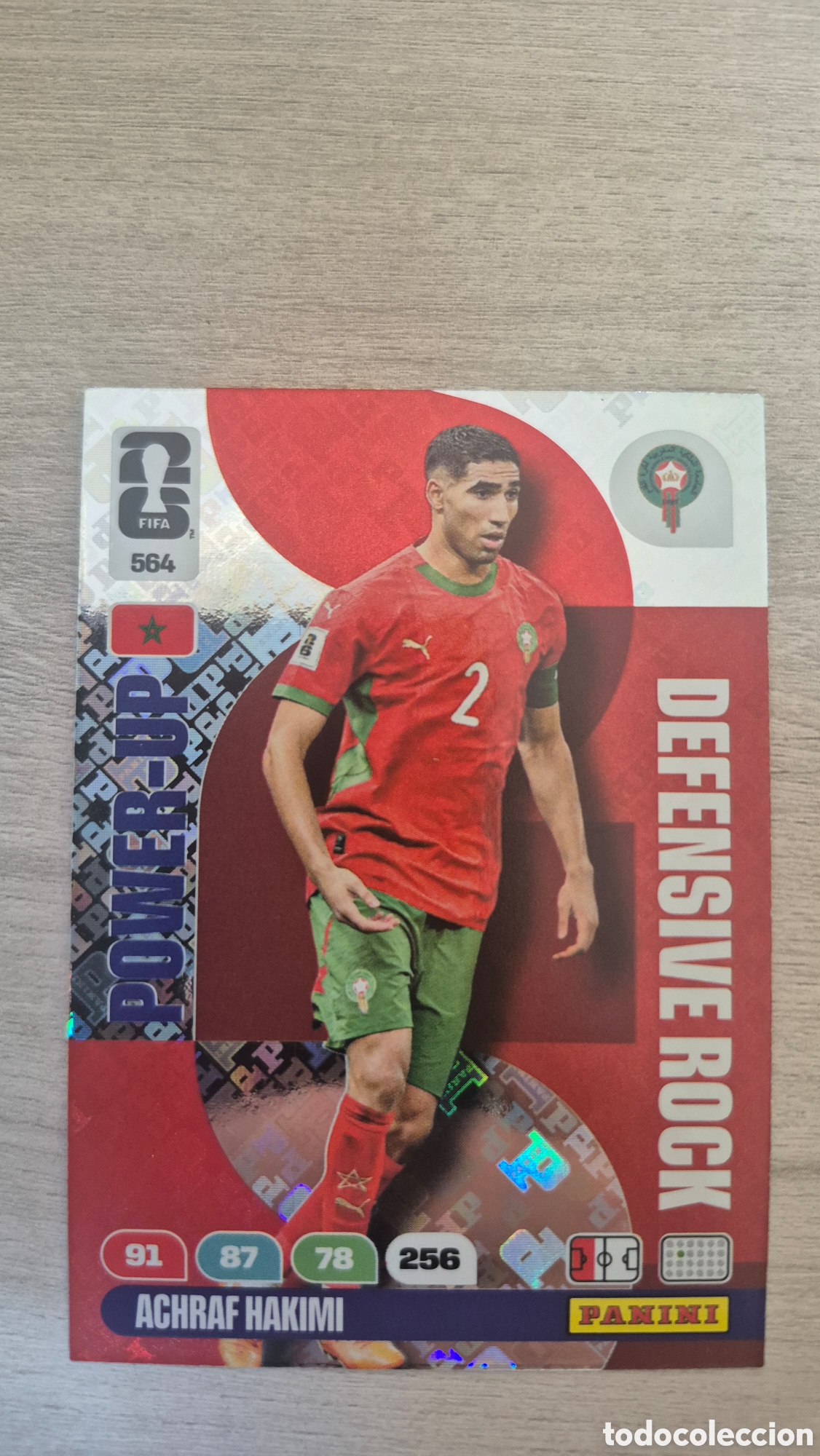 Cromos de F&uacute;tbol: N&deg;564 Power-Up Defensive Rock Achraf Hakimi Adrenalyn FIFA World Cup 26