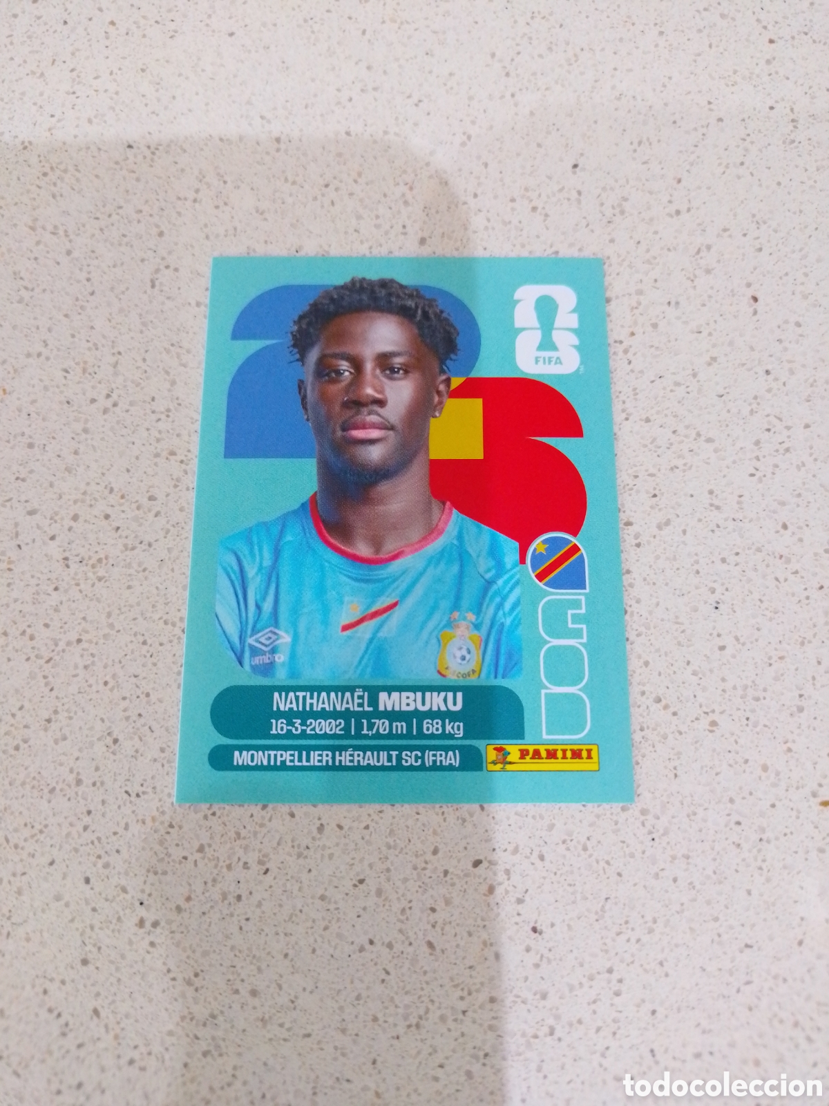Figurine di Calcio: CROMO NUMERO 20 MBUKU CONGO. MUNDIAL 2026. PANINI.