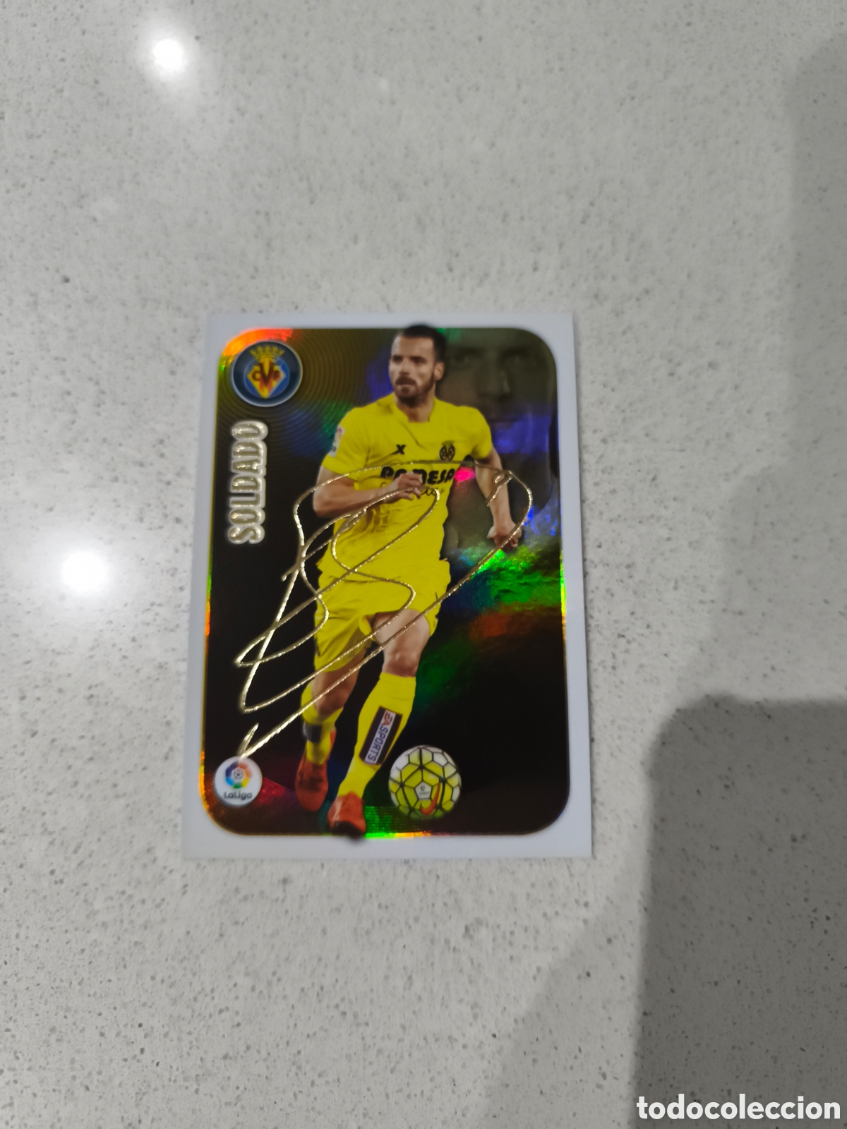 Cromos de f&uacute;tbol: CROMO SOLDADO VILLARREAL CF. SERIE ORO. LIGA ESTE 16/17. PANINI.