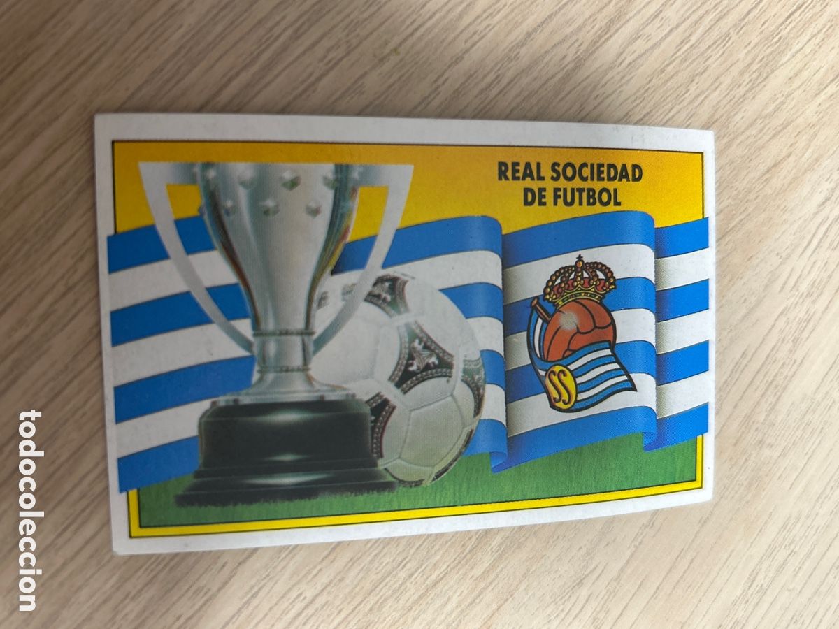 Figurine di Calcio: ESCUDO Y BANDERA REAL SOCIEDAD LIGA ESTE 1990 1991 90 91 NUNCA PEGADO SIN PEGAR