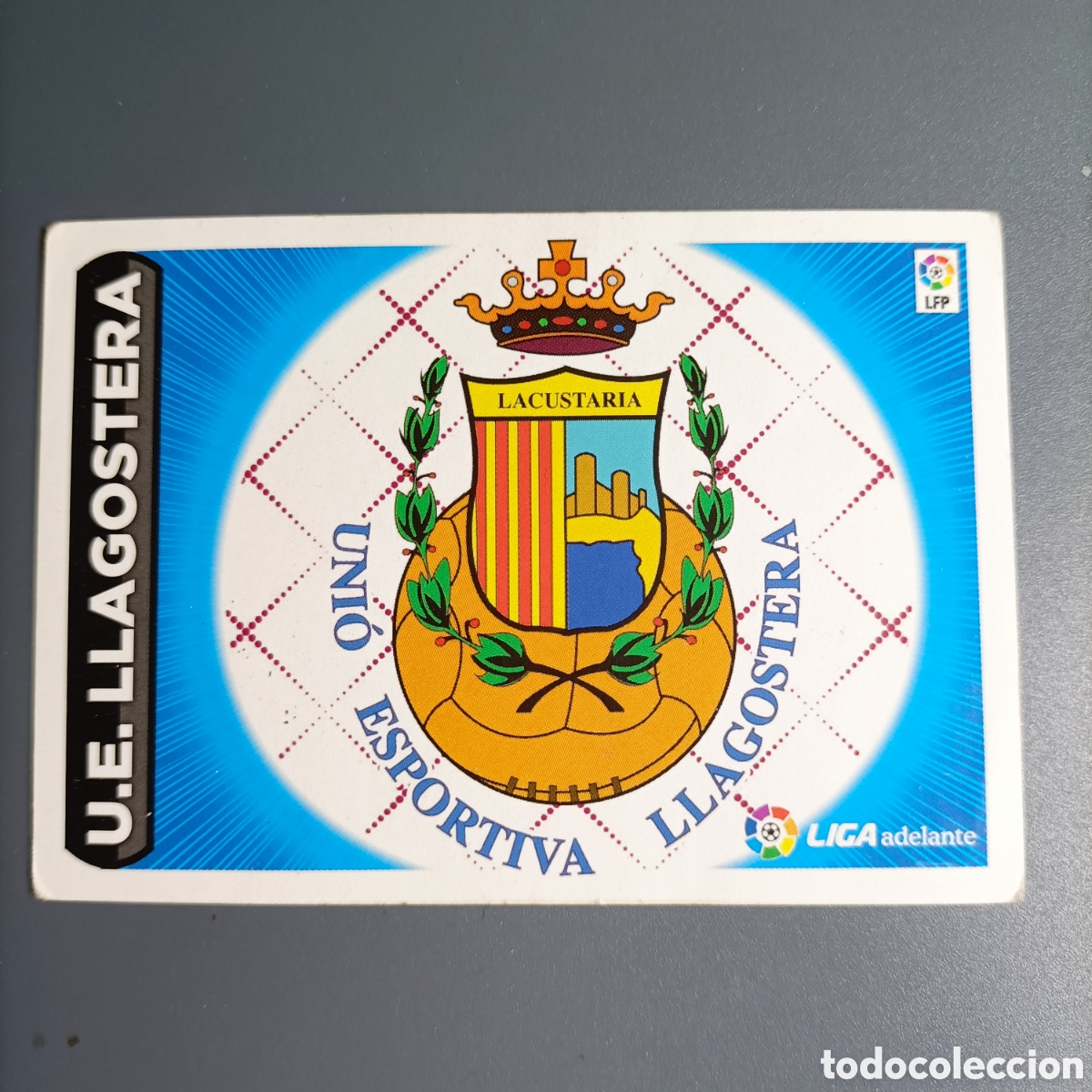 Football Stickers: CROMO ESTE. LIGA 2014-2015 (U.E LLAGOSTERA) №9 ESCUDO LIGA ADELANTE