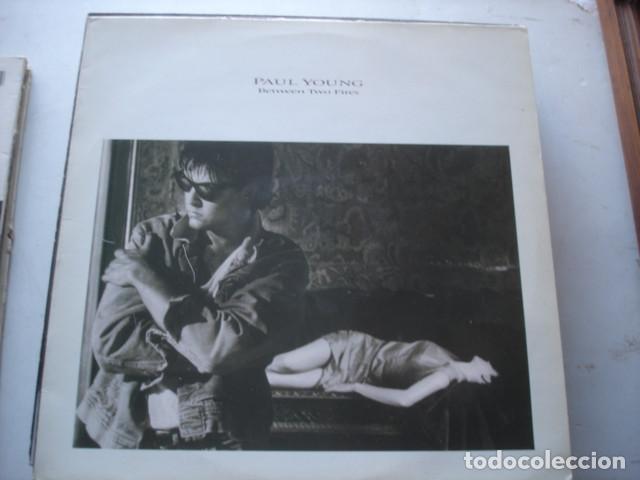 Discos de vinilo: Paul Young   Between Two Fires - Foto 1