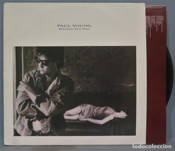 Discos de vinilo: LP. PAUL YONG. BETWEEN TWO FIRES - Foto 1