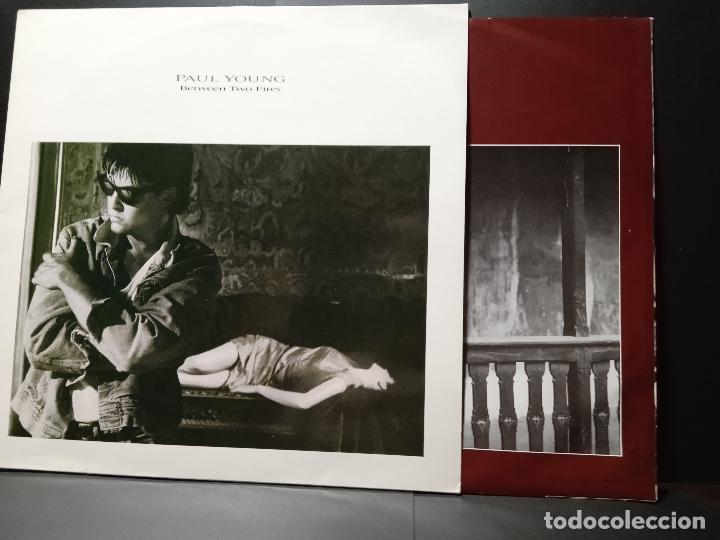 Discos de vinilo: PAUL YOUNG BETWEEN TWO FIRES LP SPAIN 1986 PDELUXE - Foto 1