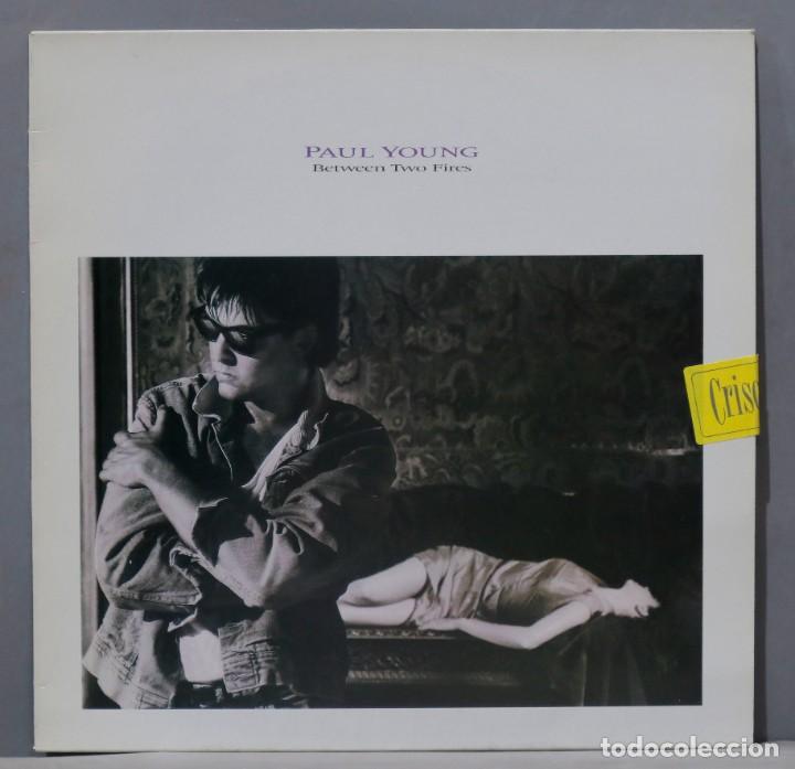 Discos de vinilo: LP. Paul Young &ndash; Between Two Fires - Foto 1
