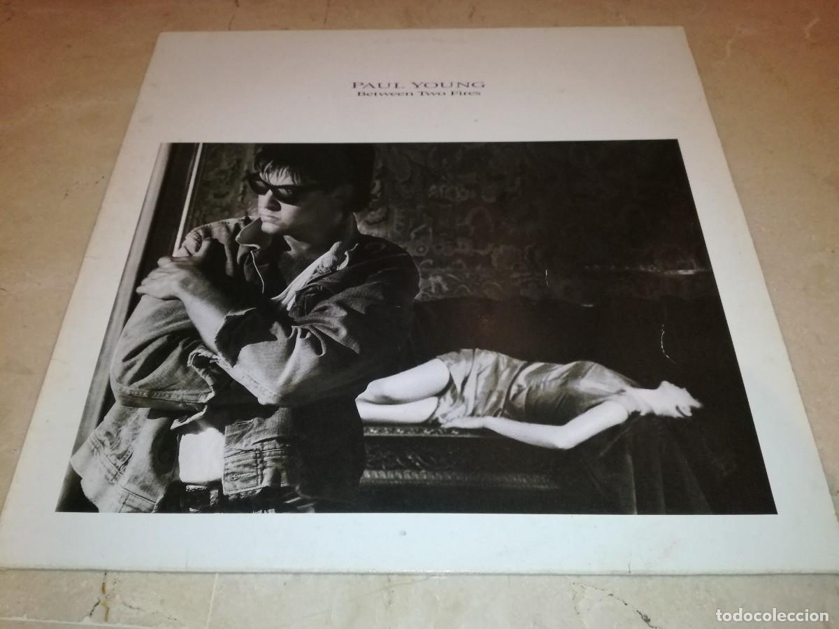 Discos de vinilo: PAUL YOUNG-BETWEEN TWO FIRES-CONTIENE ENCARTE-ORIGINAL ESPA&Ntilde;OL 1986