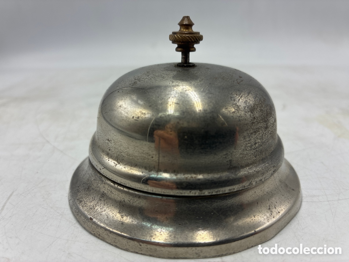 Escriban&iacute;a: Timbre de sobremesa cromado.