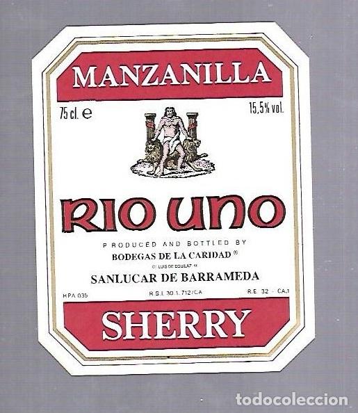 Old Labels: ETIQUETA DE VINO. MANZANILLA RIO UNO. BODEGAS DE LA CARIDAD. SANLUCAR DE BARRAMEDA