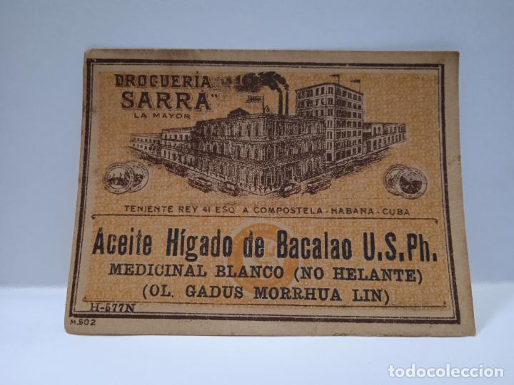 Alte Etiketten: ETIQUETA. DROGUERIA SARRA. ACEITE HIGADO DE BACALAO. MEDICINAL BLANCO. MEDIDAS : 9 X 7 CM APROX.