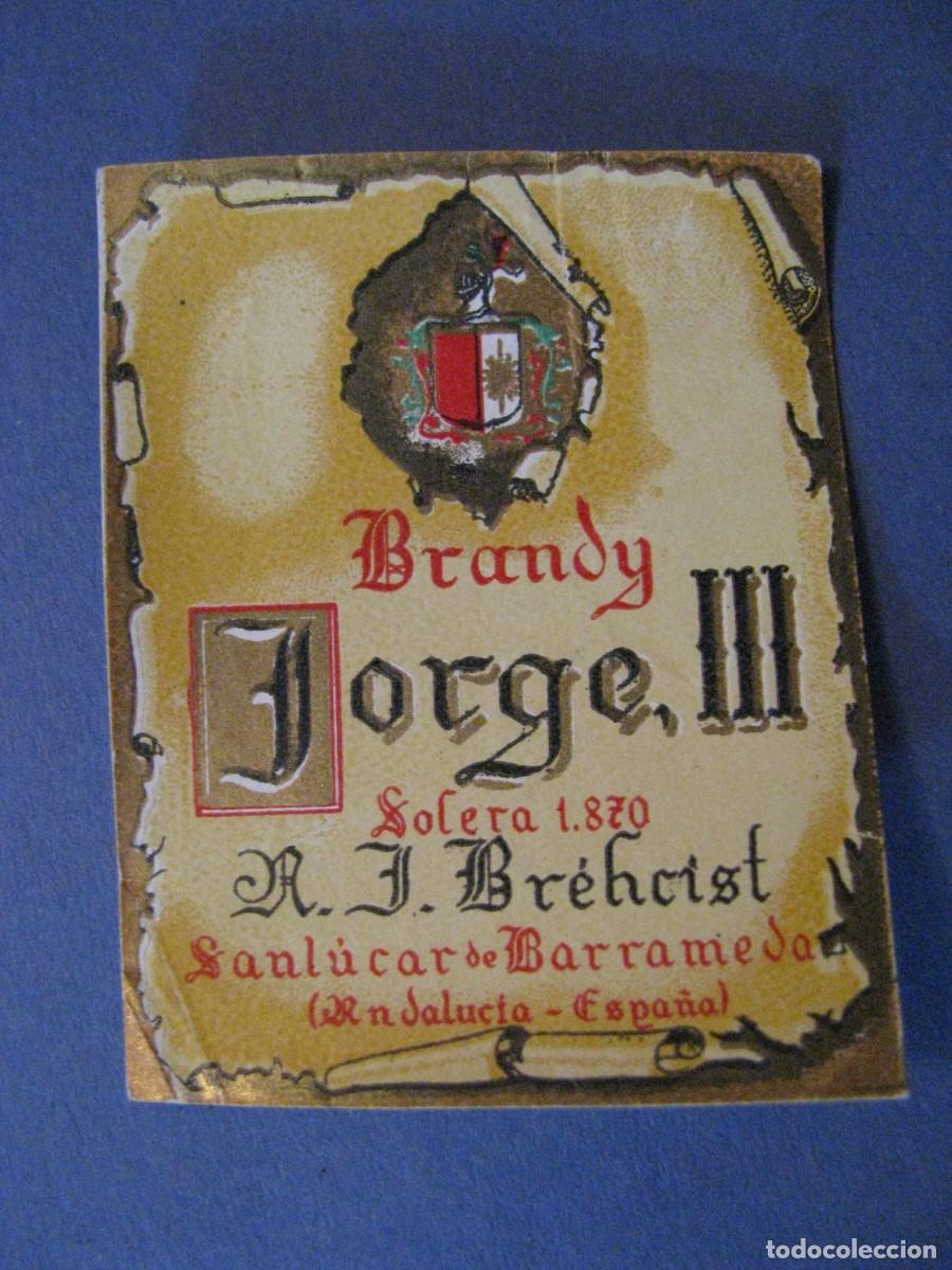 Etiquetas antiguas: ANTIGUA ETIQUETA DE BRANDY JORGE III. SOLERA 1870. SANLUCAR DE BARRAMEDA. 6X4,8 CM.