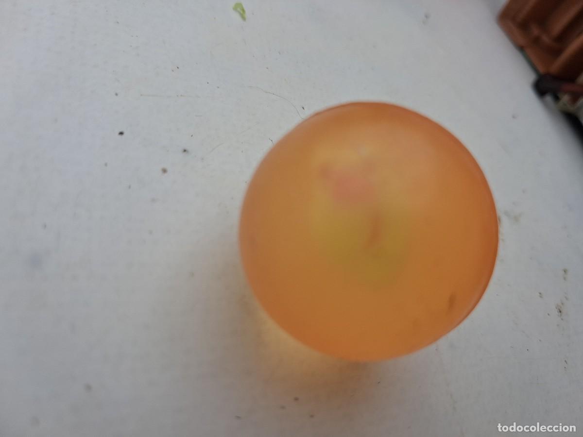 Figuras de goma y PVC: una pelota de goma - naranja transl&uacute;cida 3 cms