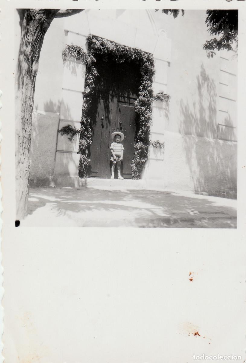 Fotograf&iacute;a antigua: Desaparecido pueblo Campos de Arenoso, Castell&oacute;n. Ni&ntilde;a en una puerta con flores. 50s sv