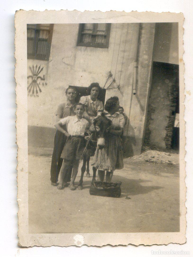 Antique Photography: Familia con burro en una calle, emblema de Falange Espa&ntilde;ola de la JONS en la pared, a&ntilde;os 40