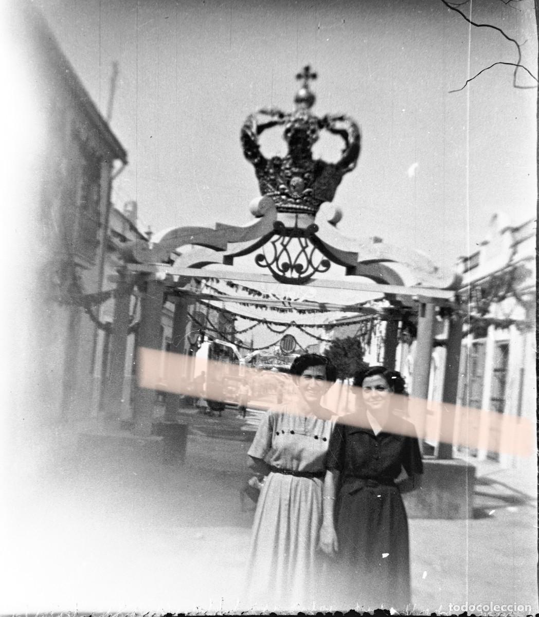 Fotograf&iacute;a antigua: Antiguo negativo de fotograf&iacute;a. Chicas en calle decorada durante las fiestas. A&ntilde;os 40