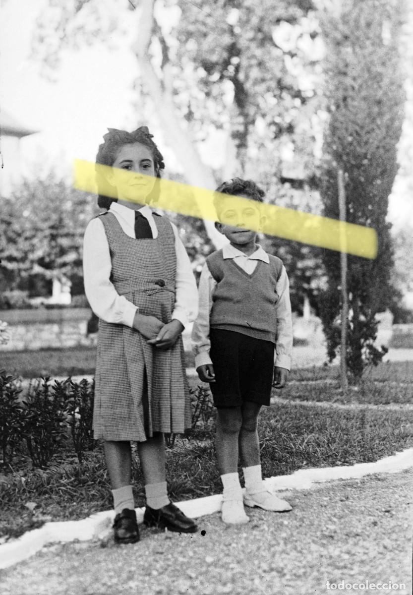 Fotograf&iacute;a antigua: Antiguo negativo de fotograf&iacute;a. Ni&ntilde;a y ni&ntilde;o posando en un jard&iacute;n. A&ntilde;os 40