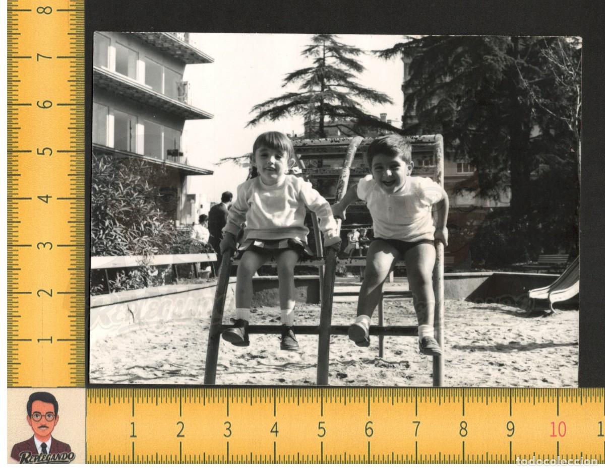 Fotograf&iacute;a antigua: PAREJA NI&Ntilde;OS SONRIEN FELICES EN UN COLUMPIO DE PARQUE - FOTO ANTIGUA A&Ntilde;OS 60 - INFANCIA ESPA&Ntilde;A