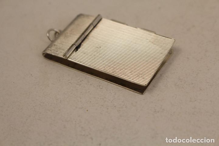 Joyeria: colgante guardanotas en alpaca