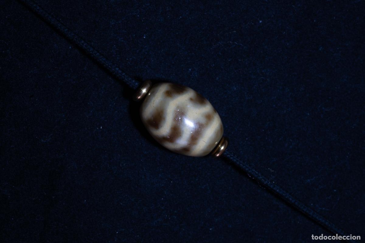 Joaillerie: Dzi tibetano de ondas de agua de la tradici&oacute;n budista china