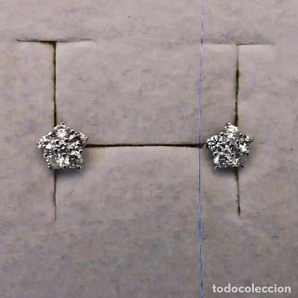 Joalharia: PENDIENTES DE ORO BLANCO CON ORLA DE 12 BTES APROX. 0,60 CTS. COLOR H, PUREZA VS. 18 KTS