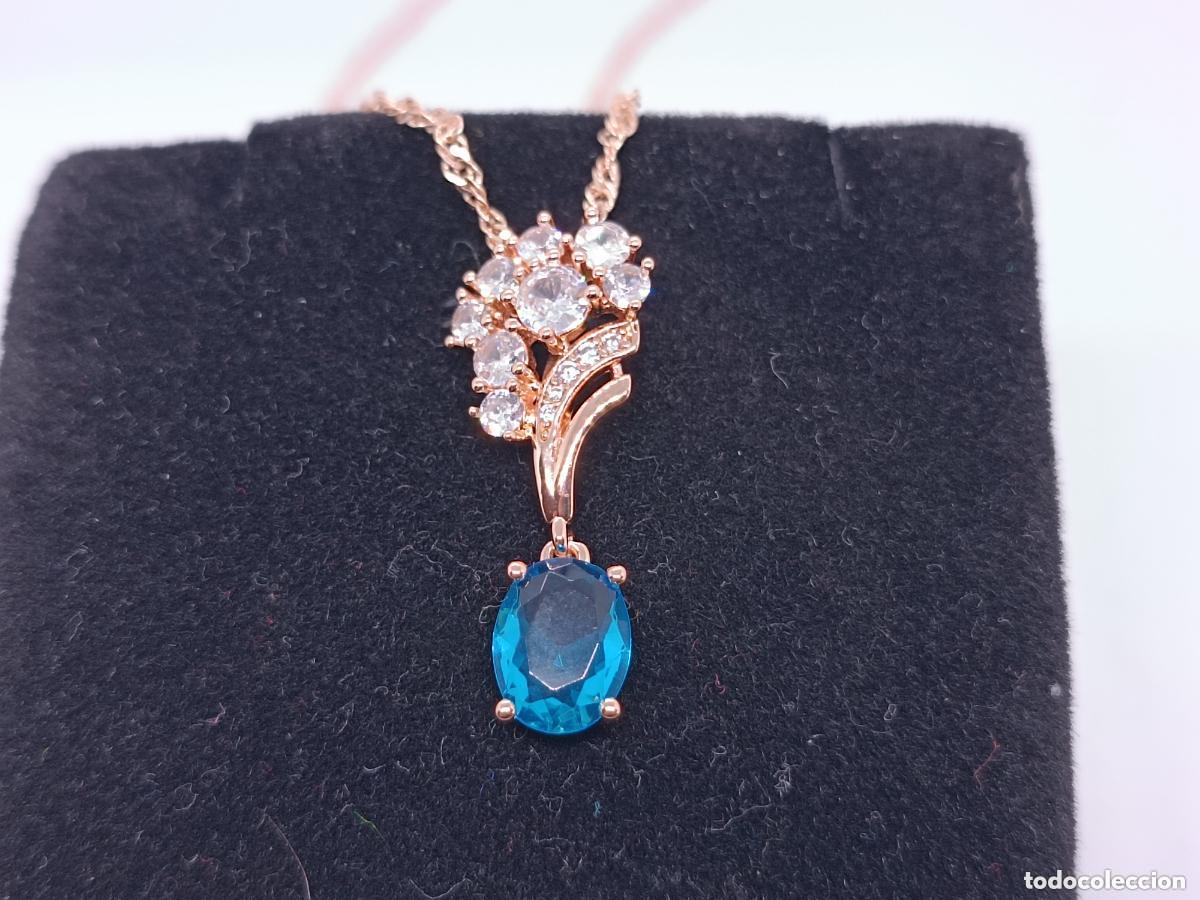 Joaillerie: Colgante en oro de 14 quilates con topacio azul con cadena
