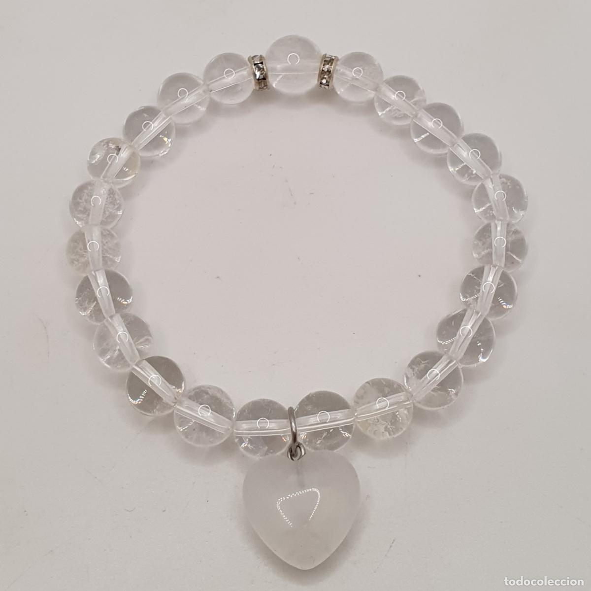 Joyeria: Bella pulsera de esferas de cuarzo, con dije de coraz&oacute;n central y cuentas de metal con circonita